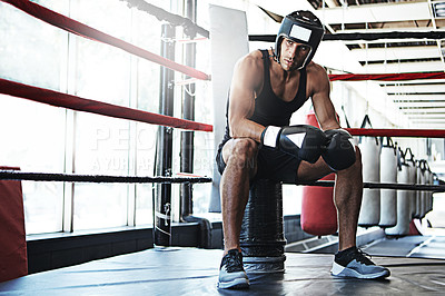 Buy stock photo Shot of a young man training in a boxing ring