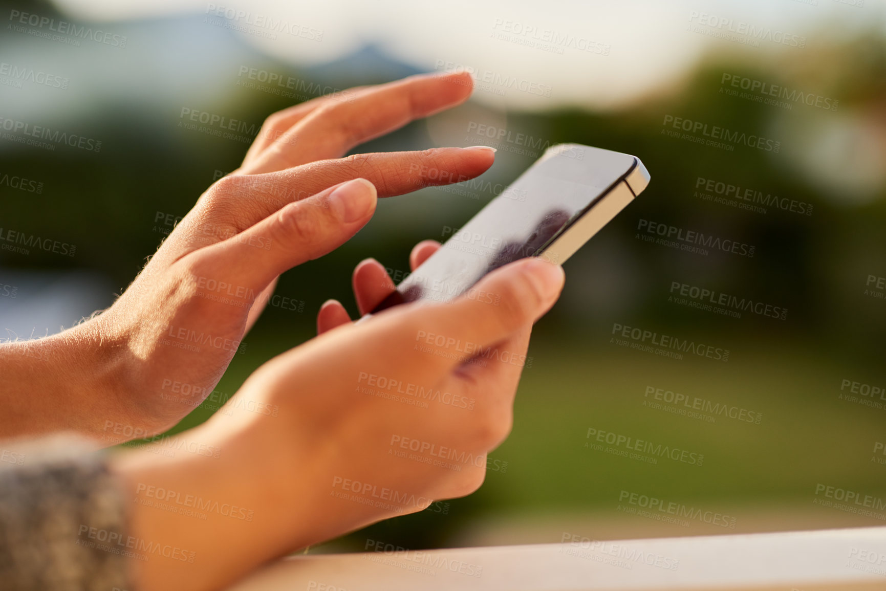 Buy stock photo Closeup shot of an unrecognisable woman using a cellphone outside