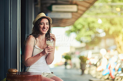 Buy stock photo Portrait of a young woman enjoying a chilled coffee beverage while on vacation