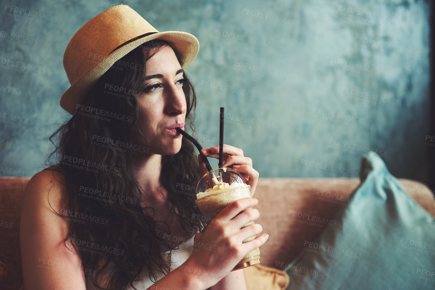 Buy stock photo Shot of a young woman enjoying a chilled coffee beverage while on vacation