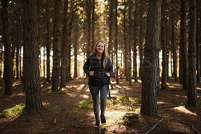 Buy stock photo Portrait of a happy young woman exploring a forest on her own