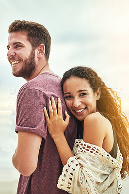 Buy stock photo Cropped shot of an affectionate young couple enjoying their time on the beach