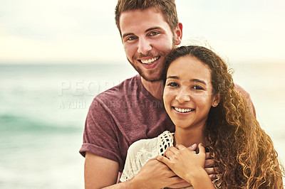 Buy stock photo Cropped portrait of an affectionate young couple enjoying their time on the beach