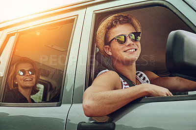 Buy stock photo Cropped shot of two friends enjoying a roadtrip together
