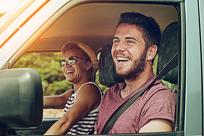 Buy stock photo Cropped shot of two young friends enjoying a roadtrip together