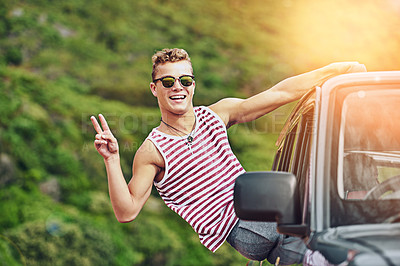 Buy stock photo Portrait of a young man leaning out the window of a car while on a roadtrip