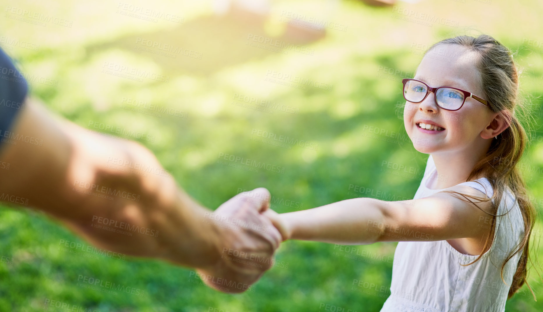 Buy stock photo Cropped shot of a little girl holding her father's hand outside