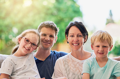 Buy stock photo Portrait of a happy family bonding together outside