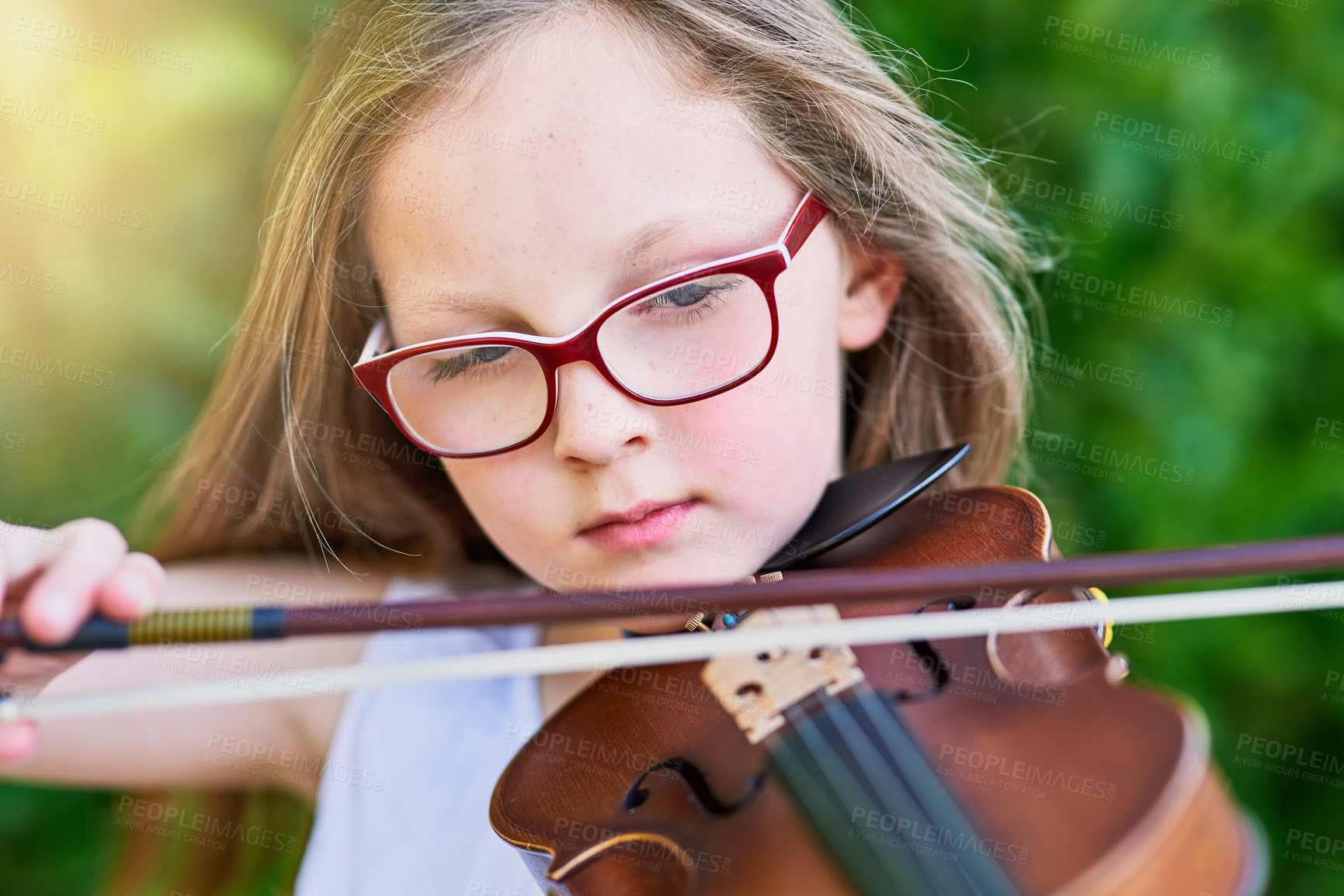 Buy stock photo Cropped shot of a little girl playing the violin outside