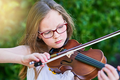 Buy stock photo Cropped shot of a little girl playing the violin outside