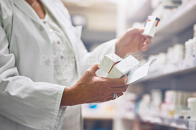 Buy stock photo Cropped shot of a pharmacist collecting medication on a prescription