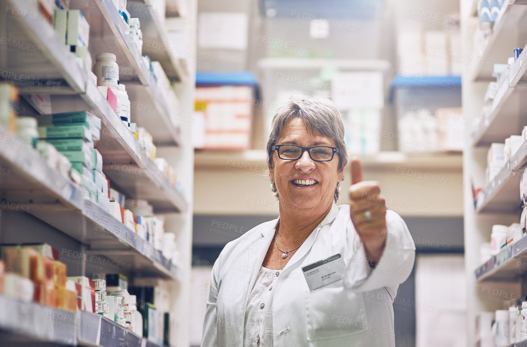 Buy stock photo Shot of a pharmacist showing thumbs up