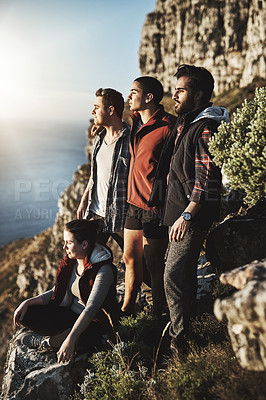 Buy stock photo Shot of a group of friends admiring the view while hiking in the mountains