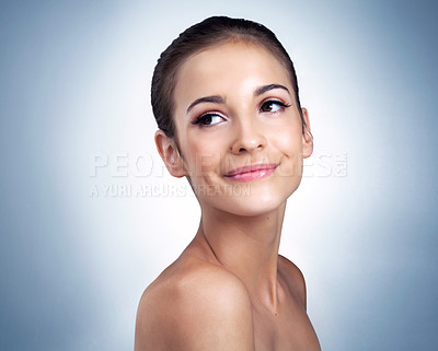 Buy stock photo Studio shot of a beautiful young model posing against a blue background