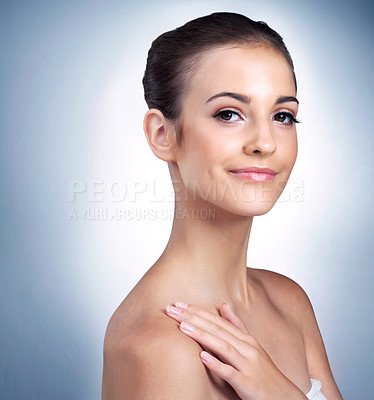 Buy stock photo Studio portrait of a beautiful young model posing against a blue background