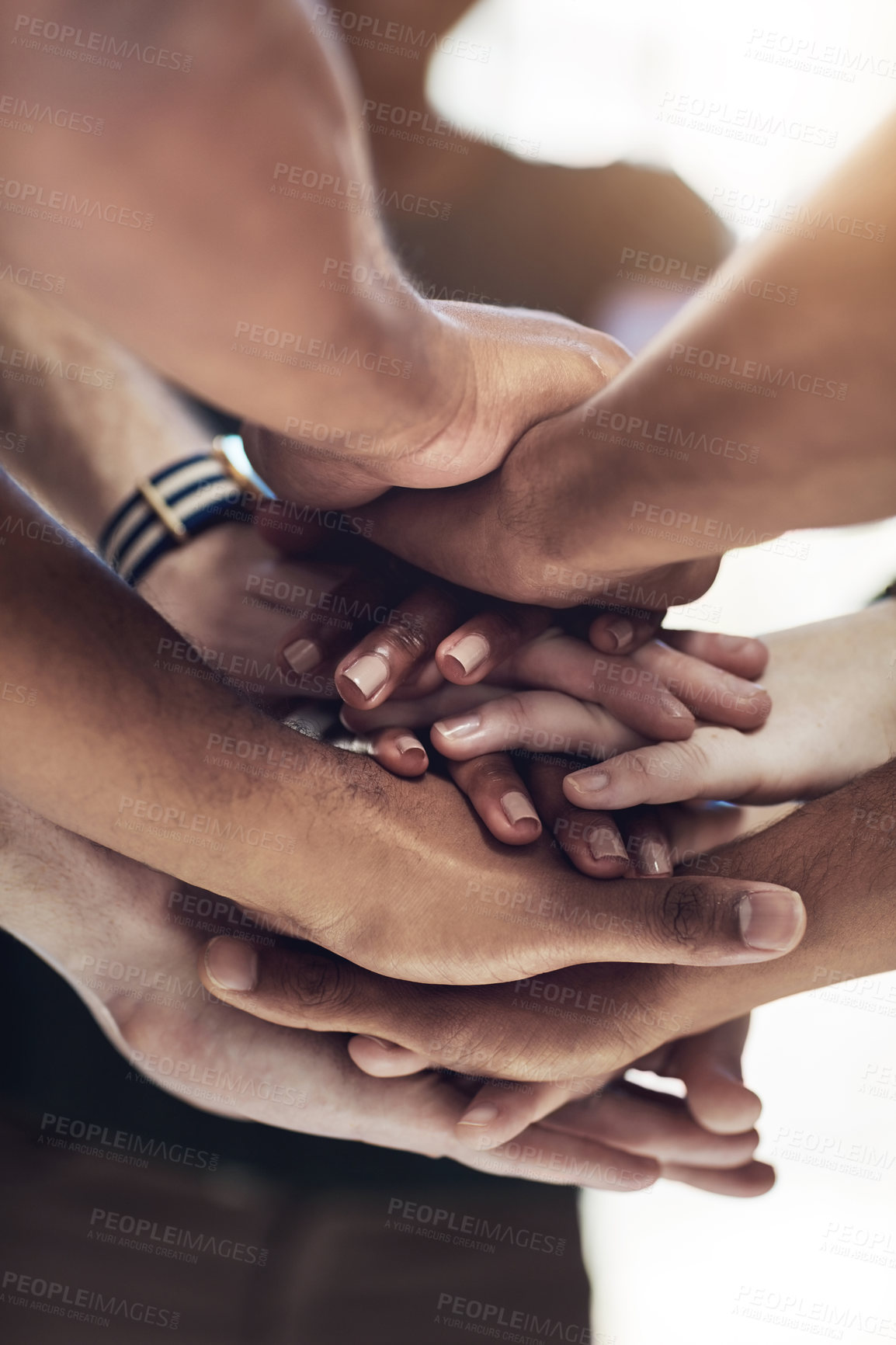 Buy stock photo Cropped shot of a work group joining hands in solidarity