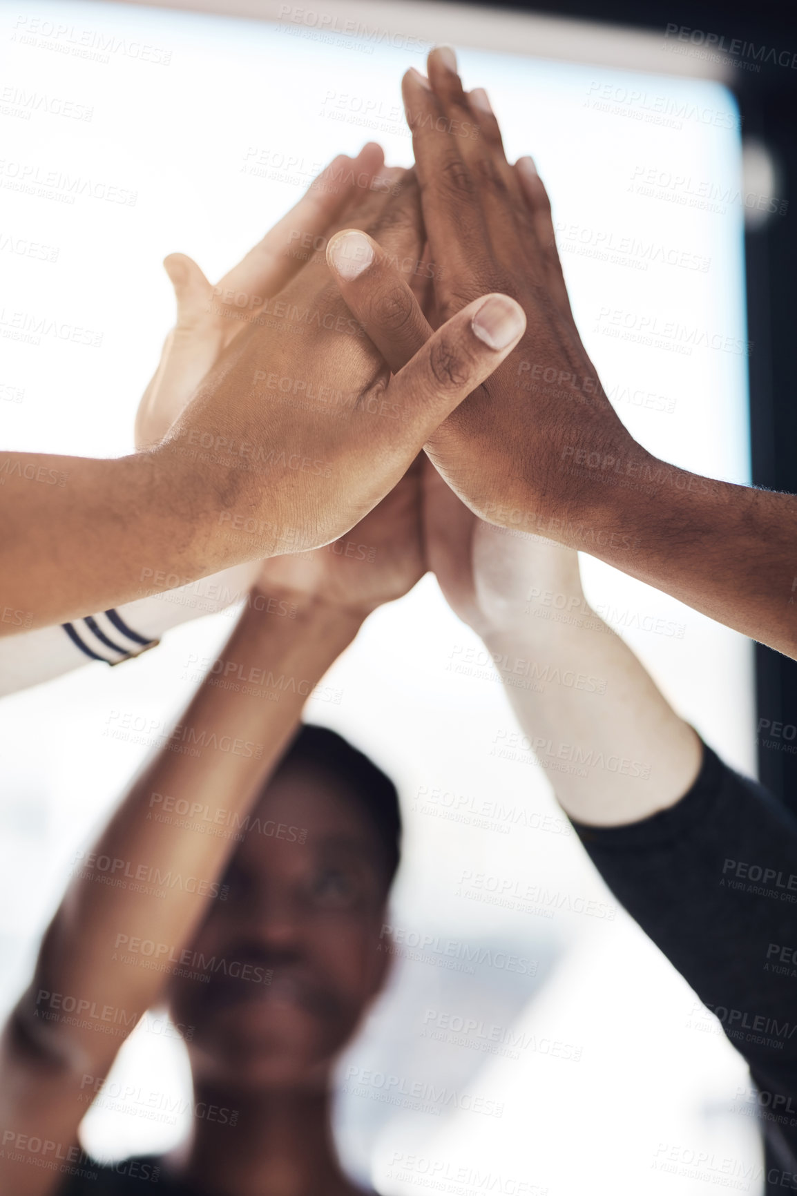 Buy stock photo Cropped shot of a group of colleagues giving each other a high five at work