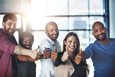 Buy stock photo Portrait of a team of happy colleagues showing thumbs up in a modern office