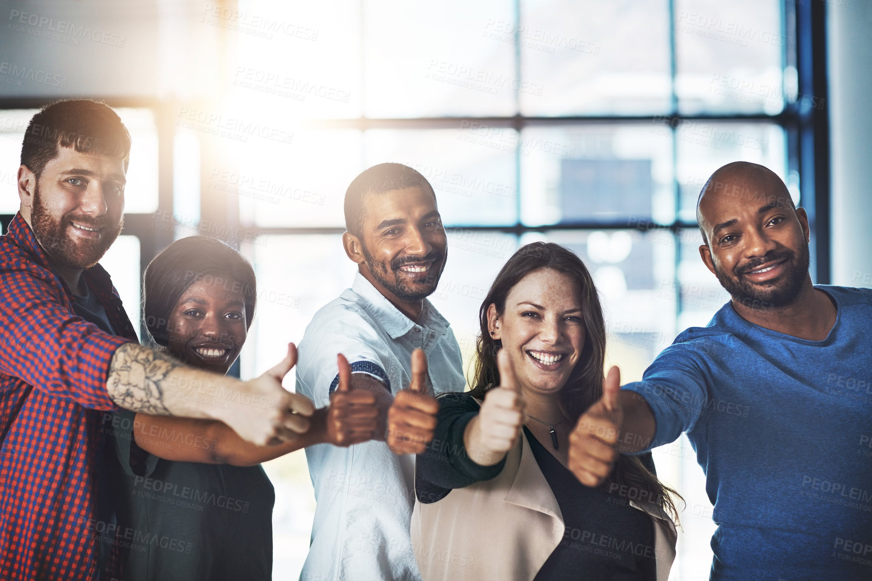 Buy stock photo Portrait of a team of happy colleagues showing thumbs up in a modern office