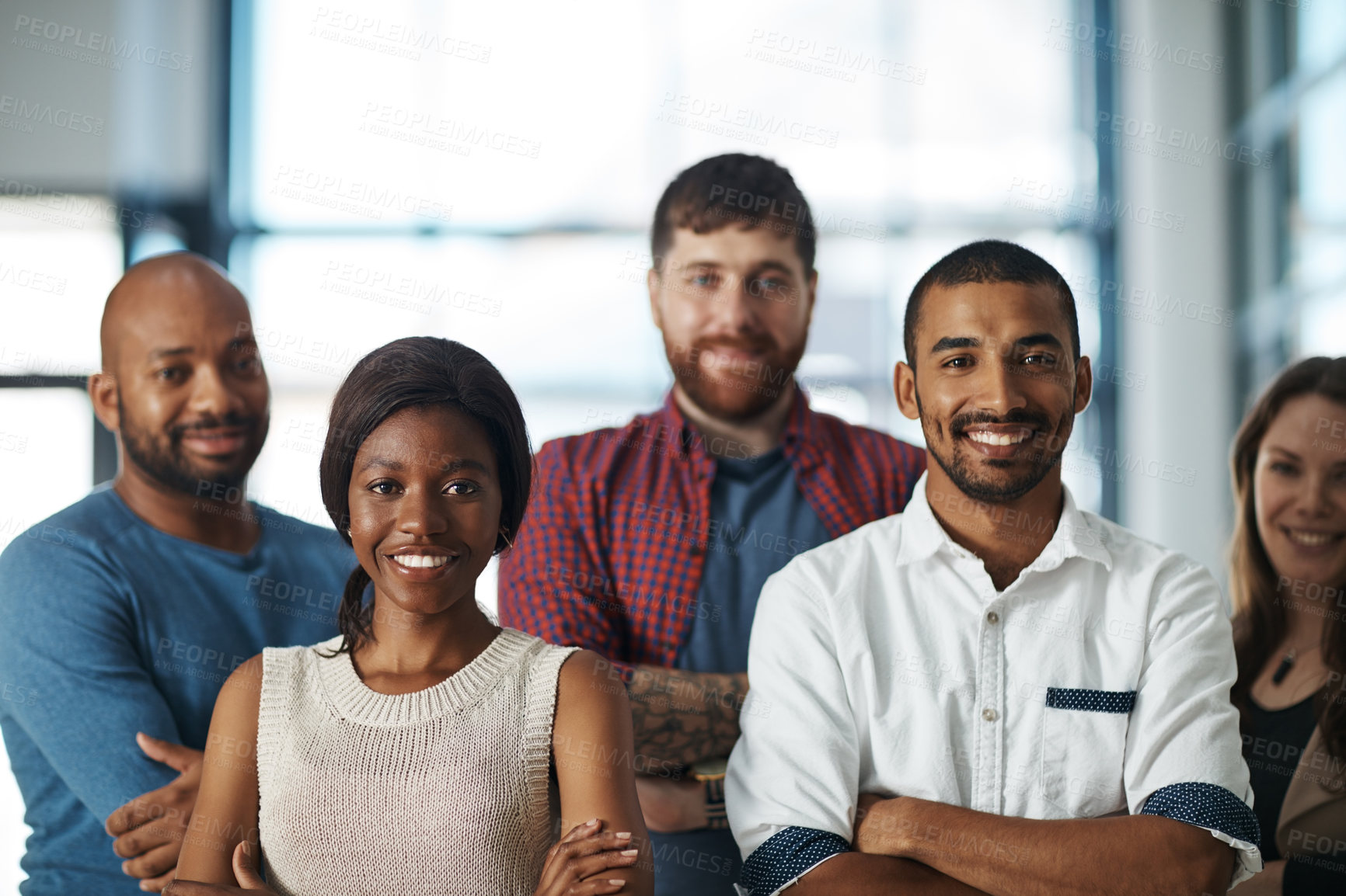 Buy stock photo Motivated, ambitious and proud creative team of men and women standing with arms folded to show unity, power and teamwork. Portrait of happy diverse group of business people feeling united together