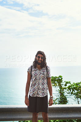 Buy stock photo Portrait of a happy young man exploring an exotic destination alone