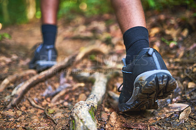 Buy stock photo Rearview shot of an unidentifiable hiker walking in the forest