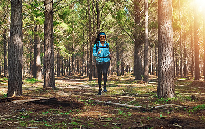 Buy stock photo Full length shot of an athletic young woman out for a jog in the woods