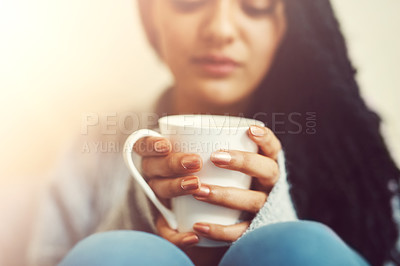 Buy stock photo Cropped shot of a young woman drinking a cup of coffee