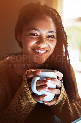 Buy stock photo Portrait of a happy young woman relaxing with a warm beverage at home