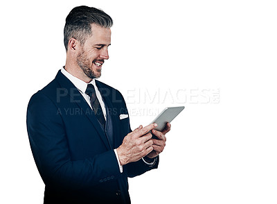 Buy stock photo Studio shot of a businessman using a digital tablet against a white background