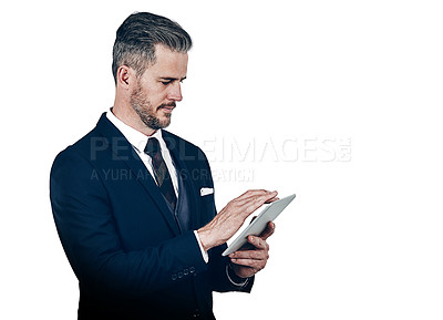 Buy stock photo Studio shot of a businessman using a digital tablet against a white background