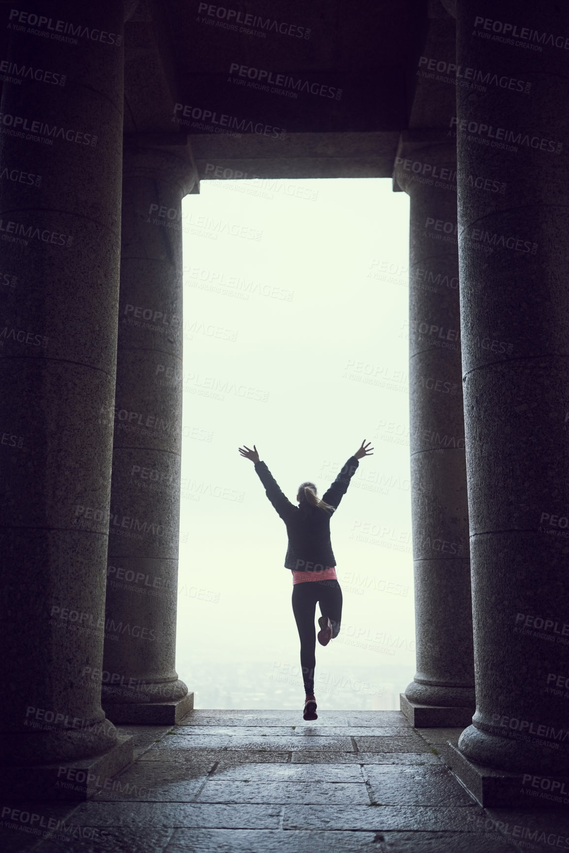 Buy stock photo Rearview shot of an unidentifiable young woman admiring a city view while out for a run