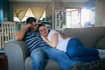 Buy stock photo Couple, relax and lying with hug on sofa for love, cuddle or support on holiday or weekend together at home. Young man and woman chilling on lounge couch with kiss for comfort in living room at house