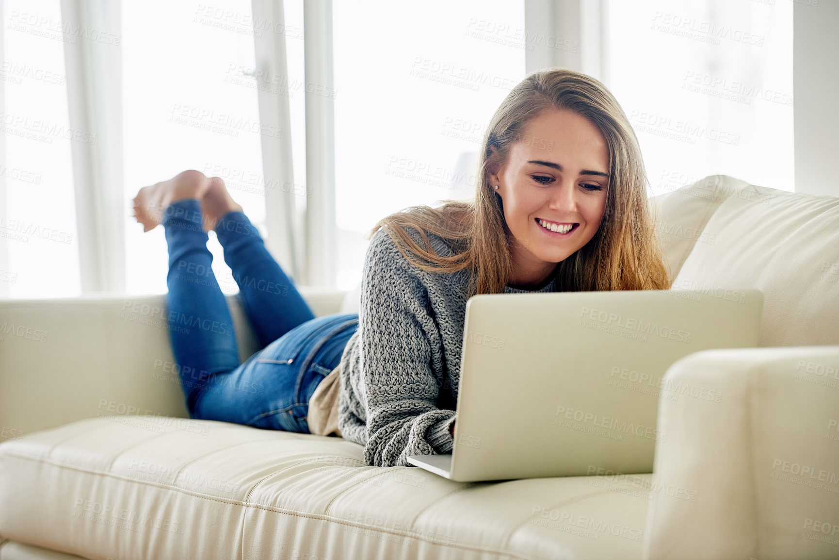 Buy stock photo Relax, woman or smile on sofa with laptop for contact, streaming or social media at home. Female student, happy and tech in living room for funny video, subscription service and online blog in Canada