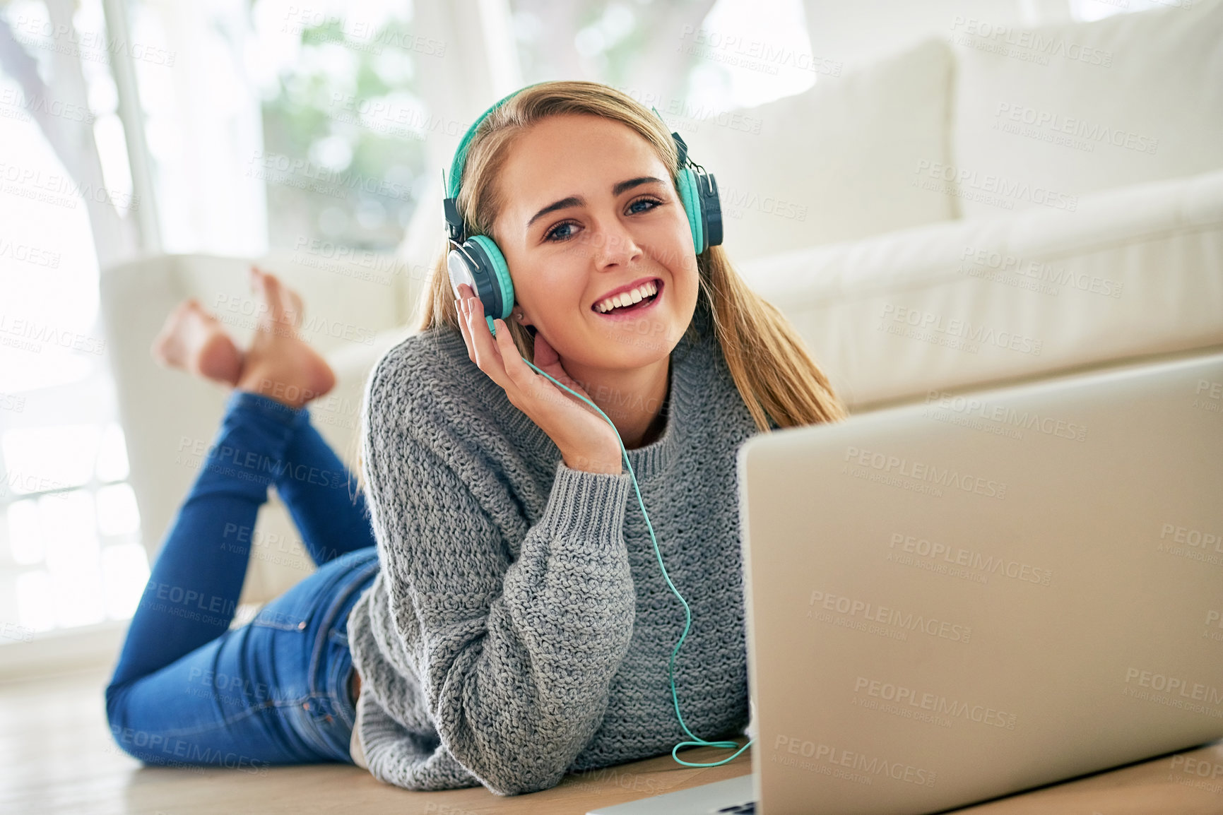 Buy stock photo Portrait, woman and relax with headphones on laptop for listening music, streaming online and podcast audio in lounge. Smile, female person and earphones with digital for browsing internet at house