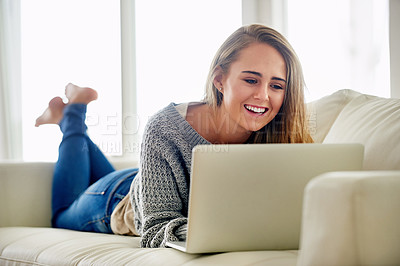 Buy stock photo Relax, woman or happy on sofa with laptop for chat, streaming or social media at home. Female student, smile and tech in living room for funny video, subscription service and online blog in Canada