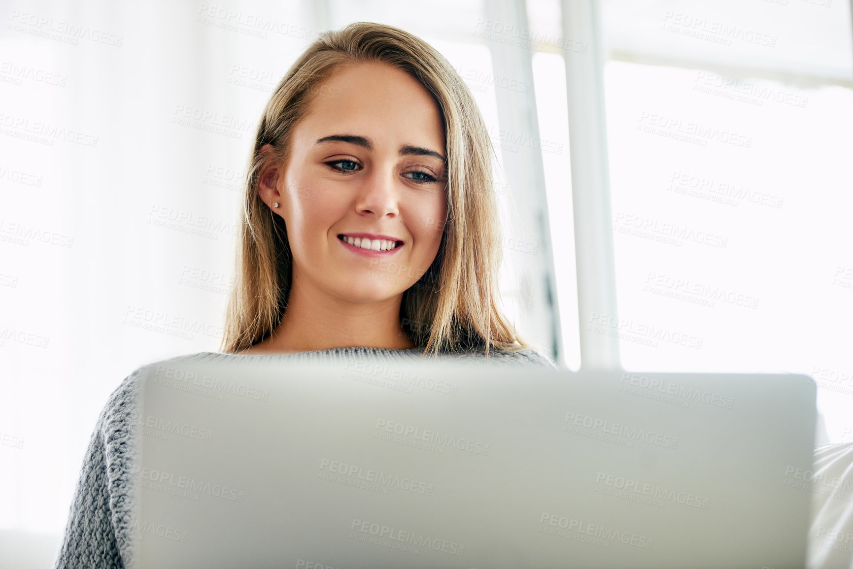 Buy stock photo Remote work, woman and smile with laptop for news, research and email at home. Female student, happy and computer in living room for job searching, internship opportunity and feedback in Australia