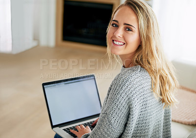 Buy stock photo High angle portrait of an attractive young woman using her laptop at home