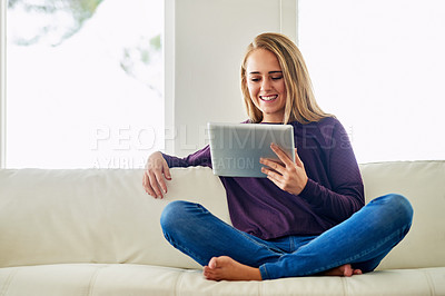 Buy stock photo Reading, online and woman with tablet, smile and happy for romance ebook in lounge, chill and home. Living room, relax and girl on sofa, digital and entertainment of fiction with internet in app