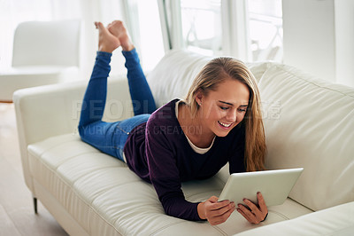 Buy stock photo Woman, house and relaxing on sofa with tablet for social media, online post or watch videos for fun. Female person, couch and smile or laugh in lounge for entertainment, streaming service and website