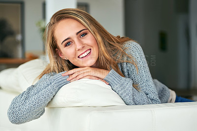 Buy stock photo Cropped portrait of an attractive young woman chilling on the sofa at home