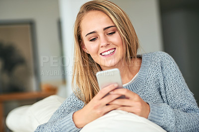 Buy stock photo Woman, home and relaxing on sofa with smartphone for social media, online post and watch videos for fun. Girl, couch and smile or laugh in lounge for entertainment, streaming service and website