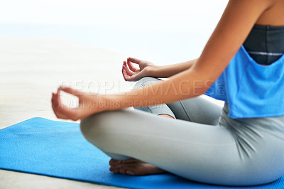 Buy stock photo Cropped shot of a young woman practising the lotus pose