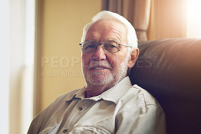 Buy stock photo Cropped portrait of a happy senior man relaxing on the sofa at home