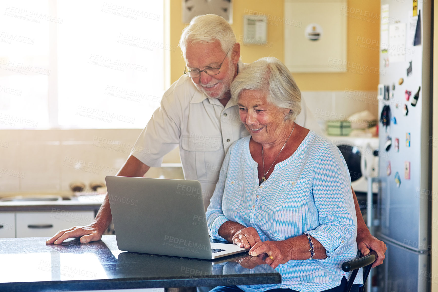 Buy stock photo Elderly, couple and smile with laptop in kitchen for internet, website and reading elections results. Home, senior man and woman with technology on table for political, registration and online news