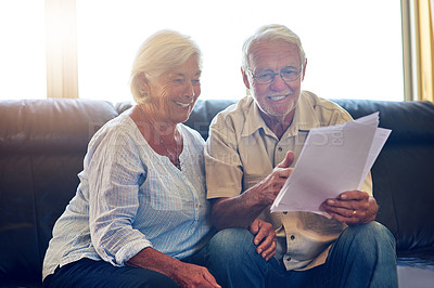 Buy stock photo Senior couple, reading and documents on sofa with smile for investment, pension and information for wealth. Old man, elderly woman and happy with paperwork, savings and results for finance in home