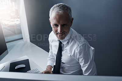 Buy stock photo Shot of a focussed businessman working behind his computer in the office