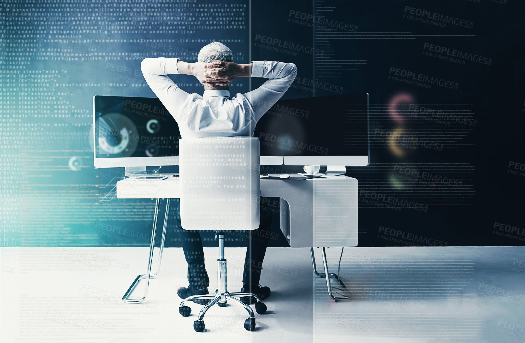 Buy stock photo Rearview shot of a businessman sitting at his desk in the office