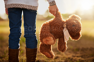 Buy stock photo Rearview shot of an unidentifiable little girl walking in the park with her teddy bear