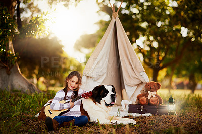 Buy stock photo Portrait of a cute little girl playing outside a teepee with her dog